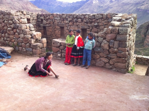 cute Quechua girls are playing in the ruins